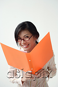 AsiaPix - A woman smiles at the camera as she holds an orange folder
