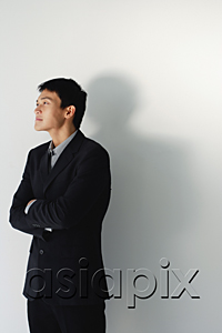 AsiaPix - A man wearing a suit crosses his arms