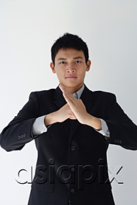 AsiaPix - A man in a business suit makes a threatening gesture