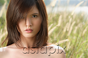AsiaPix - Woman in long grass looking at camera
