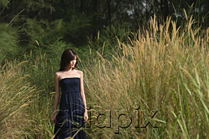 AsiaPix - Woman walking in long grass