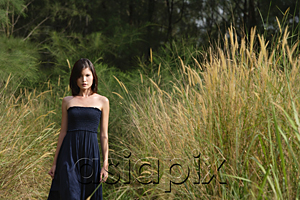 AsiaPix - Woman walking in long grass