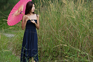 AsiaPix - Woman in long grass with parasol