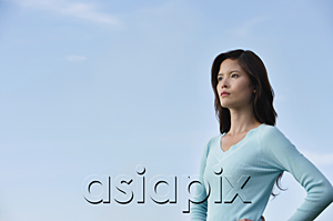 AsiaPix - Woman with hands on hips looking into the distance