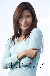 AsiaPix - Woman with arms crossed, smiling at camera