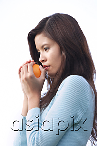 AsiaPix - Woman holding orange