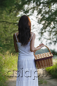 AsiaPix - Woman with basket walking down country road