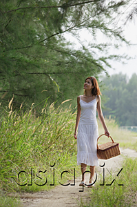AsiaPix - Woman with basket walking down country road