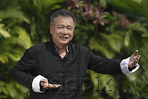 AsiaPix - Man practicing Tai Chi in the park