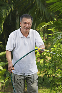 AsiaPix - Man with hose, watering garden