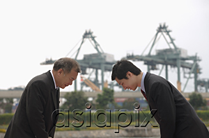 AsiaPix - Businessmen standing face to face, bowing