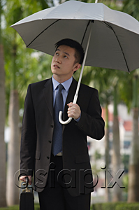 AsiaPix - Businessman holding umbrella