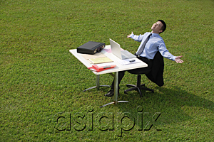 AsiaPix - Businessman relaxing at office desk