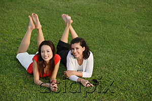 AsiaPix - Two women relaxing in the park, looking at camera