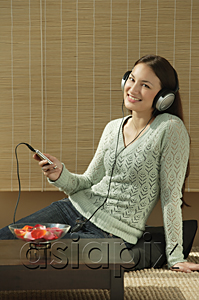 AsiaPix - Young woman listening to music