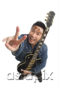 AsiaPix - Man holding guitar, giving peace sign and smiling at camera