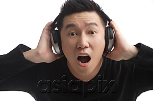 AsiaPix - Man with headphones looking surprised at camera