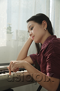 AsiaPix - Young woman playing keyboard