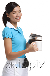 AsiaPix - Waitress smiling at camera, pouring coffee