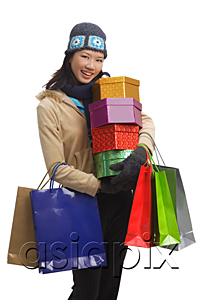 AsiaPix - Young woman with gift boxes and shopping bags, smiling at camera