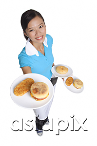 AsiaPix - Waitress smiling at camera, serving breakfast