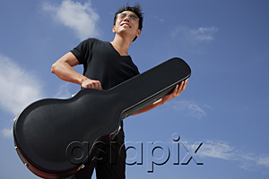 AsiaPix - Man holding guitar case