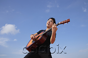 AsiaPix - Man playing guitar outdoors