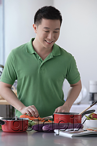 AsiaPix - Man cooking in the kitchen