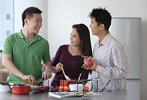 AsiaPix - Friends cooking in the kitchen