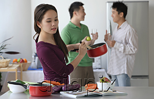 AsiaPix - Woman cooking while men talk