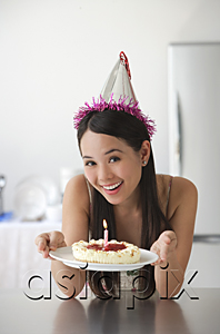 AsiaPix - Young woman with cake smiling