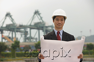 AsiaPix - Engineer with plans and hard helmet looking at camera