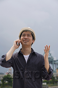 AsiaPix - Man with hard helmet talking on the phone