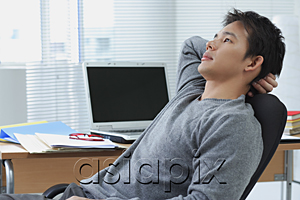 AsiaPix - Man leaning back in office chair
