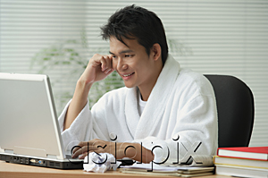 AsiaPix - Man in bathrobe working at computer