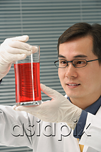 AsiaPix - Scientist examining container of fluid