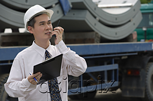 AsiaPix - Man with hard helmet speaking into walkie talkie