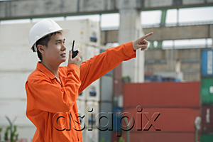 AsiaPix - Construction worker giving directions on walkie talkie