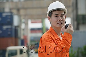 AsiaPix - Construction worker talking on walkie talkie