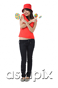 AsiaPix - Young woman with lollipop smiling at camera