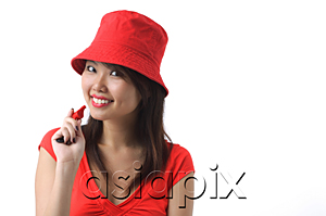 AsiaPix - Young woman with whistle smiling at camera
