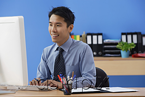 AsiaPix - Businessman working at computer