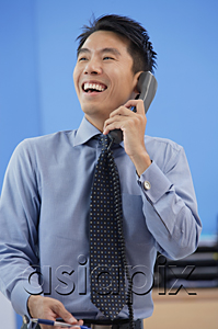 AsiaPix - Businessman laughing while on the phone