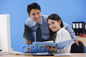 AsiaPix - Businessman and woman smiling at camera