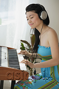 AsiaPix - Young woman playing keyboard