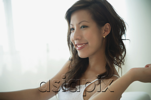 AsiaPix - Young woman relaxing in living room