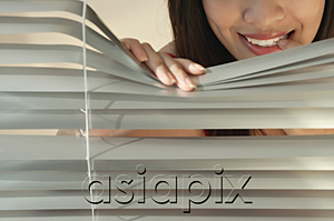 AsiaPix - Young woman behind Venetian blinds