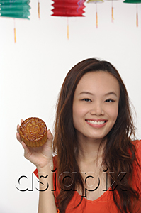 AsiaPix - Young woman with Chinese lantern smiling at camera