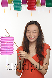 AsiaPix - Young woman with Chinese lantern smiling at camera