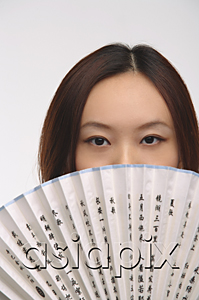 AsiaPix - Young woman with fan looking at camera